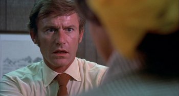 Movie still from “Dirty Mary Crazy Larry” (1974), directed by John Hough – An older man wearing a yellow tie and a white shirt; Close Up shot, Over the shoulder angle