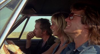 Movie still from “Dirty Mary Crazy Larry” (1974), directed by John Hough – A group of people sitting in the back seat of a car; Close Up shot, Low angle