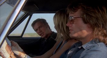 Movie still from “Dirty Mary Crazy Larry” (1974), directed by John Hough – A man and two women sitting in the back of a car; Close Up shot, Over the shoulder angle