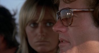 Movie still from “Dirty Mary Crazy Larry” (1974), directed by John Hough – A man and a woman wearing glasses looking at each other; Close Up shot, Low angle