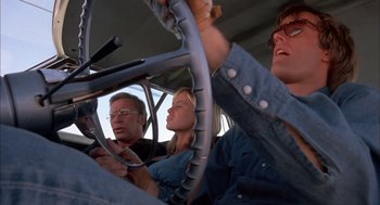 Movie still from “Dirty Mary Crazy Larry” (1974), directed by John Hough – A group of people sitting in a vehicle; Medium shot, Low angle