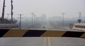 Movie still from “Dirty Mary Crazy Larry” (1974), directed by John Hough – A view of an empty road from a car window; Extreme Wide shot, High angle