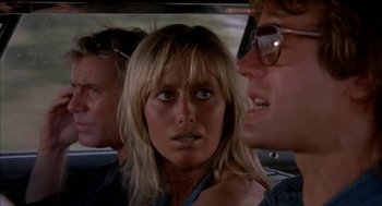 Movie still from “Dirty Mary Crazy Larry” (1974), directed by John Hough – A woman in a car with two men in the backseat; Close Up shot, Low angle