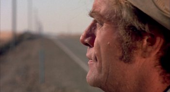Movie still from “Dirty Mary Crazy Larry” (1974), directed by John Hough – A man's face looking up at the sky; Close Up shot, Over the shoulder angle