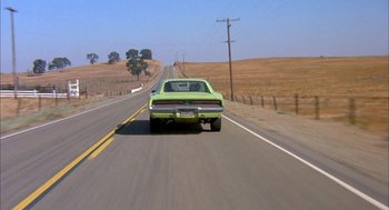Movie still from “Dirty Mary Crazy Larry” (1974), directed by John Hough – A green car is driving down the road; Wide shot, High angle