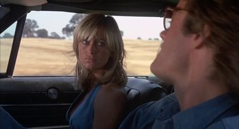 Movie still from “Dirty Mary Crazy Larry” (1974), directed by John Hough – A man and a woman sitting in the back of a car; Close Up shot, Over the shoulder angle