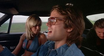 Movie still from “Dirty Mary Crazy Larry” (1974), directed by John Hough – A man and a woman are sitting in a car; Close Up shot, Low angle