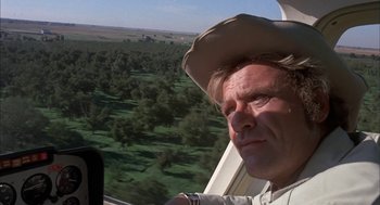 Movie still from “Dirty Mary Crazy Larry” (1974), directed by John Hough – A man wearing a cowboy hat looking out the window of an airplane; Close Up shot, Low angle