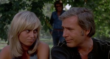 Movie still from “Dirty Mary Crazy Larry” (1974), directed by John Hough – A man and a woman sitting next to each other in a park; Close Up shot, Low angle