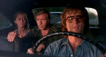 Movie still from “Dirty Mary Crazy Larry” (1974), directed by John Hough – A group of people sitting in the back of a car; Medium shot, Low angle