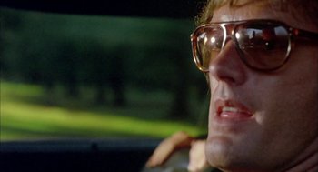 Movie still from “Dirty Mary Crazy Larry” (1974), directed by John Hough – A person wearing sunglasses in a car; Close Up shot, Low angle