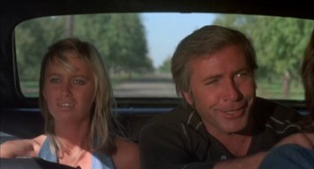 Movie still from “Dirty Mary Crazy Larry” (1974), directed by John Hough – A man and a woman sitting in the back of a car; Close Up shot, Low angle