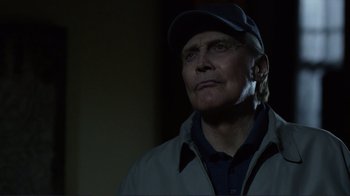 Movie still from “Do You Believe?” (2015), directed by Jon Gunn – An older man wearing a baseball cap and jacket; Close Up shot, Low angle