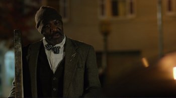 Movie still from “Do You Believe?” (2015), directed by Jon Gunn – An older man wearing a suit and a bow tie; Close Up shot, Over the shoulder angle
