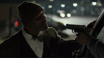 Movie still from “Do You Believe?” (2015), directed by Jon Gunn – A man holding a gun while standing next to another man; Close Up shot, Over the shoulder angle