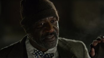 Movie still from “Do You Believe?” (2015), directed by Jon Gunn – An older man wearing a hat and a tie; Close Up shot, Over the shoulder angle
