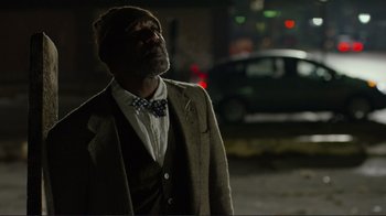 Movie still from “Do You Believe?” (2015), directed by Jon Gunn – An older man wearing a suit and bow tie; Medium shot, Over the shoulder angle