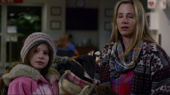 Movie still from “Do You Believe?” (2015), directed by Jon Gunn – A woman and a girl sitting on a couch; Close Up shot, Over the shoulder angle