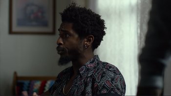 Movie still from “Do You Believe?” (2015), directed by Jon Gunn – A person with a beard wearing a shirt; Close Up shot, Over the shoulder angle