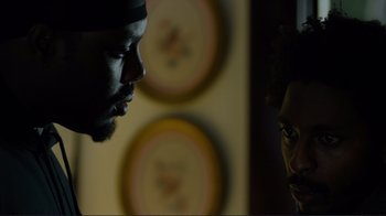 Movie still from “Do You Believe?” (2015), directed by Jon Gunn – A man and a woman face to face in a dark room; Close Up shot, Over the shoulder angle