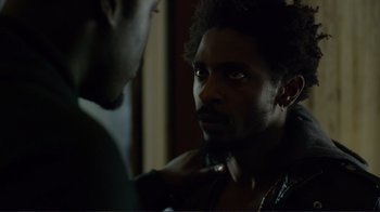 Movie still from “Do You Believe?” (2015), directed by Jon Gunn – A man looking into a mirror while another man looks on; Close Up shot, Over the shoulder angle
