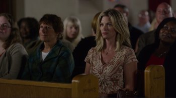 Movie still from “Do You Believe?” (2015), directed by Jon Gunn – Two women are sitting in a church with other people in the background; Medium shot, Over the shoulder angle