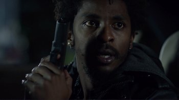 Movie still from “Do You Believe?” (2015), directed by Jon Gunn – A person holding a gun in his hand; Close Up shot, Low angle