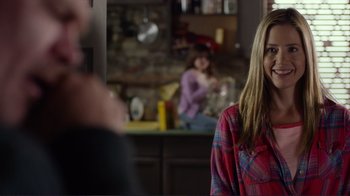 Movie still from “Do You Believe?” (2015), directed by Jon Gunn – A woman standing in a kitchen next to two other people; Medium shot, Over the shoulder angle