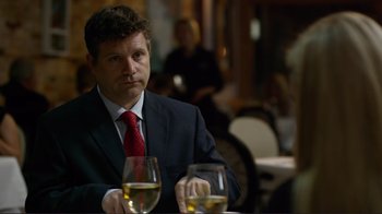 Movie still from “Do You Believe?” (2015), directed by Jon Gunn – A man sitting at a table with two glasses of wine; Close Up shot, Over the shoulder angle