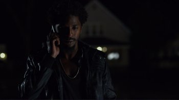 Movie still from “Do You Believe?” (2015), directed by Jon Gunn – A man in a leather jacket talking on a cell phone; Close Up shot, Low angle