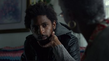 Movie still from “Do You Believe?” (2015), directed by Jon Gunn – A man with a beard is sitting in front of a mirror; Close Up shot, Over the shoulder angle