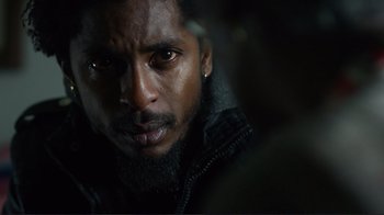 Movie still from “Do You Believe?” (2015), directed by Jon Gunn – A person wearing a jacket; Extreme Close Up shot, Over the shoulder angle