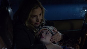 Movie still from “Do You Believe?” (2015), directed by Jon Gunn – A woman is holding a young child in her arms; Close Up shot, Low angle
