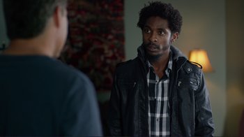 Movie still from “Do You Believe?” (2015), directed by Jon Gunn – A man in a black jacket is talking to another man in a black jacket; Medium shot, Over the shoulder angle