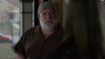 Movie still from “Do You Believe?” (2015), directed by Jon Gunn – An older man with a beard wearing glasses and a hat; Close Up shot, Over the shoulder angle