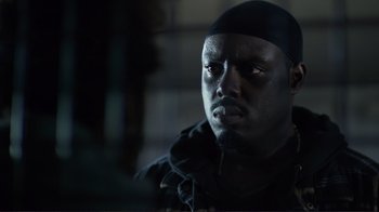 Movie still from “Do You Believe?” (2015), directed by Jon Gunn – A man with a black hat is looking at the camera; Close Up shot, Low angle
