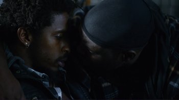 Movie still from “Do You Believe?” (2015), directed by Jon Gunn – Two men touching each other's faces in the dark; Close Up shot, Over the shoulder angle