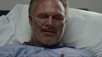 Movie still from “Do You Believe?” (2015), directed by Jon Gunn – An older man laying in a hospital bed with his eyes closed; Close Up shot, Low angle