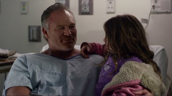 Movie still from “Do You Believe?” (2015), directed by Jon Gunn – A man and a little girl are in a hospital room; Close Up shot, Over the shoulder angle