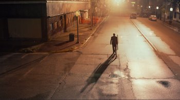 Movie still from “Do You Believe?” (2015), directed by Jon Gunn – A man walking down a street at night; Extreme Wide shot, High angle