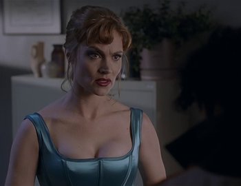 Movie still from “Doctor Who: The Movie” (1996), directed by Geoffrey Sax – A woman in a blue dress is looking at the camera; Close Up shot, Over the shoulder angle