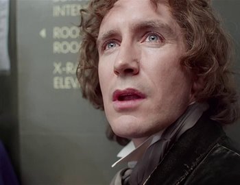 Movie still from “Doctor Who: The Movie” (1996), directed by Geoffrey Sax – A person with curly hair; Close Up shot, Low angle