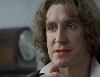 Movie still from “Doctor Who: The Movie” (1996), directed by Geoffrey Sax – A person with long curly hair; Close Up shot, Over the shoulder angle