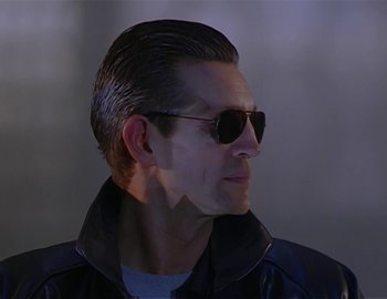 Movie still from “Doctor Who: The Movie” (1996), directed by Geoffrey Sax – A person wearing a jacket and sunglasses; Close Up shot, Low angle