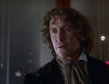 Movie still from “Doctor Who: The Movie” (1996), directed by Geoffrey Sax – A person wearing a suit and tie; Close Up shot, Over the shoulder angle