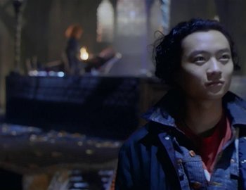 Movie still from “Doctor Who: The Movie” (1996), directed by Geoffrey Sax – A man standing in front of a fireplace; Close Up shot, Low angle