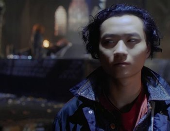 Movie still from “Doctor Who: The Movie” (1996), directed by Geoffrey Sax – A young man with dark curly hair wearing a blue jacket; Close Up shot, Low angle