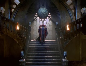 Movie still from “Doctor Who: The Movie” (1996), directed by Geoffrey Sax – A man and woman walking down a set of stairs; Wide shot, High angle