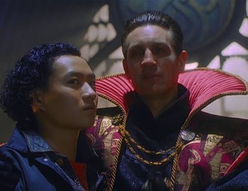 Movie still from “Doctor Who: The Movie” (1996), directed by Geoffrey Sax – Two men dressed up in costumes posing for a picture; Medium shot, Low angle