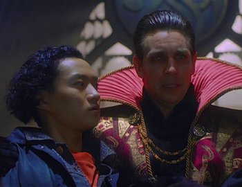 Movie still from “Doctor Who: The Movie” (1996), directed by Geoffrey Sax – Two men are dressed up and looking at each other; Medium shot, Low angle